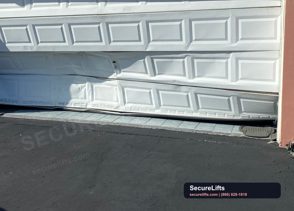 Damaged garage door before SecureLifts repair