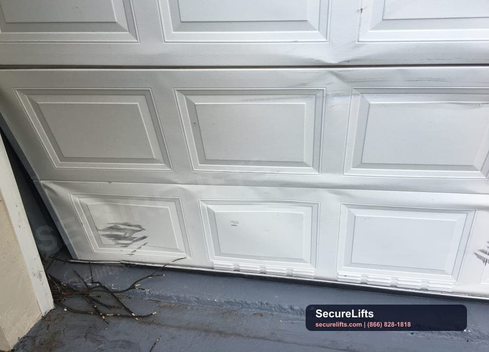 Real damaged garage door panel inspected by SecureLifts