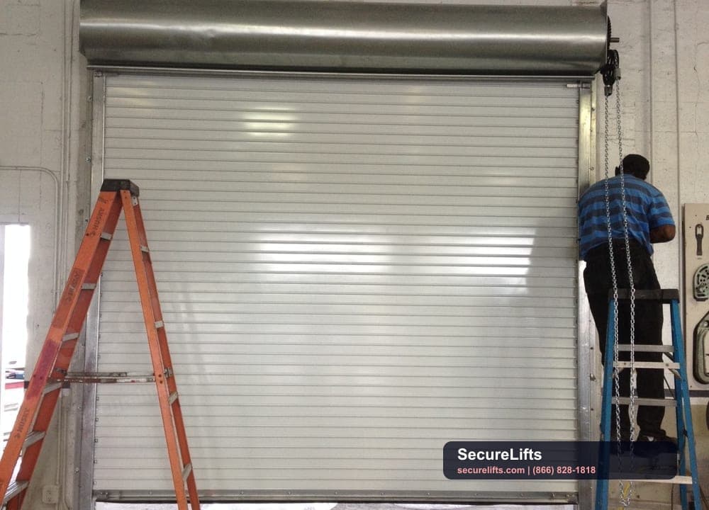 Technician servicing a commercial roll-up door